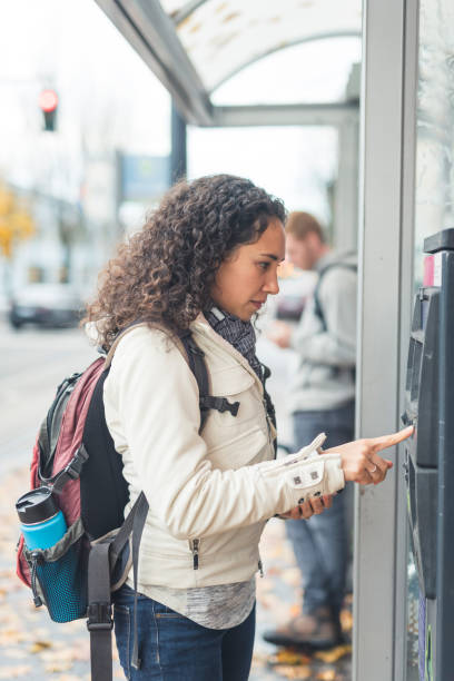 istock Young Woman Buying Fare for Public Transit 943608334
