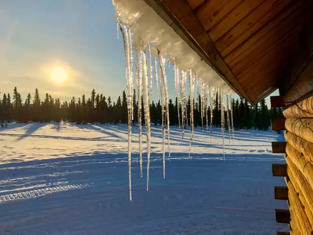 Photo of Icicles on roof and sunset