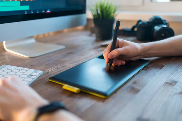 istock Working space of Digital Artist with Drawing tablet in front of computer 943620310