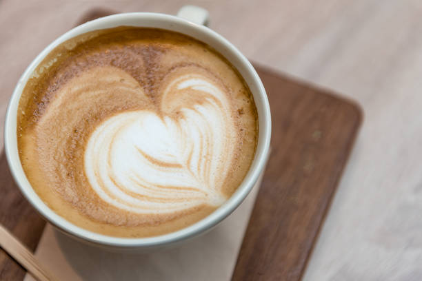 istock hot cappuccino on wooden table 943620836