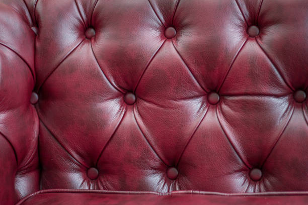 istock Closeup texture of vintage red leather sofa for background 943620874