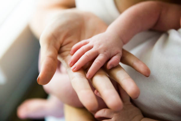 istock Newborn Baby Hand in Mother's Hand 943621062