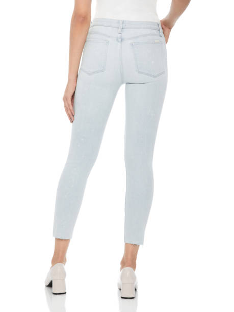 istock Woman in tight jeans and heels, white background 943621178