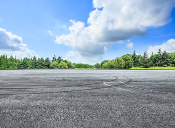 istock empty asphalt road and green forest in summer 943623484