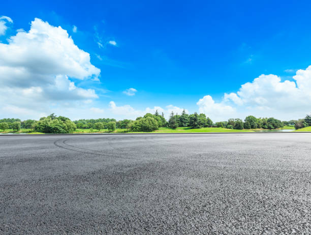 istock empty asphalt road and green forest in summer 943623498