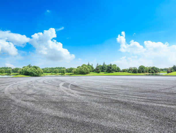 istock empty asphalt road and green forest in summer 943623670