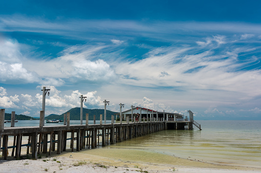 Tropical landscape of Koh Rong Sanloem island with white pier and beautiful beach in the distance. Cambodia, asia.
