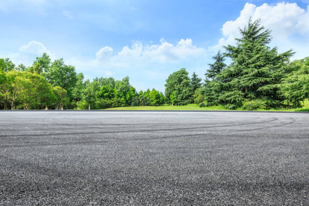 istock empty asphalt road and green forest in summer 943623882