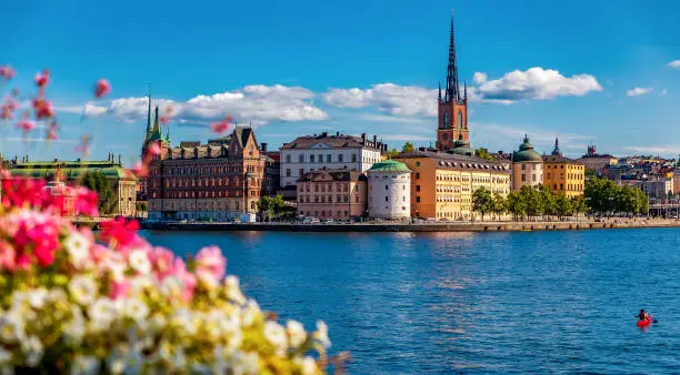 Panoramic view across Lake Malaren onto traditional gothic buildings in the old town, Gamla Stan in and Riddarholmen church, the burial church of Swedish monarchs in Stockholm, Sweden