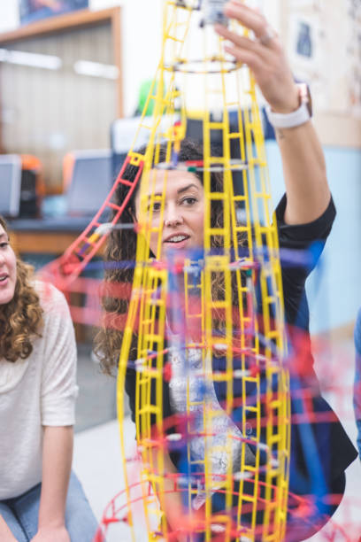 istock Ethnic art teacher shows her class a colorful example of sculpture 943624534