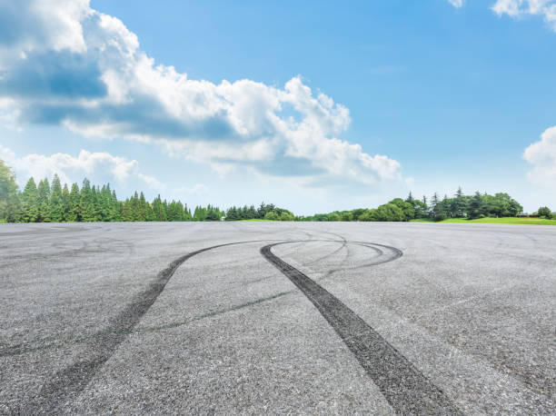 istock empty asphalt road and green forest in summer 943624602