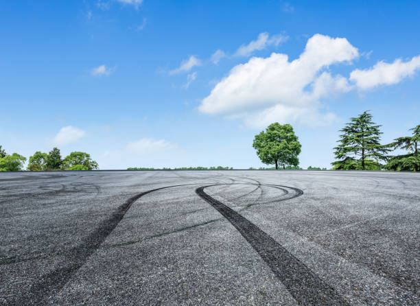 istock empty asphalt road and green forest in summer 943627852