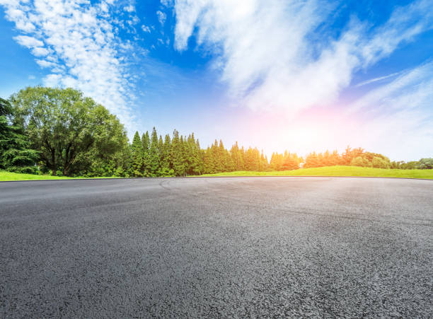 istock empty asphalt road and green forest in summer 943631342