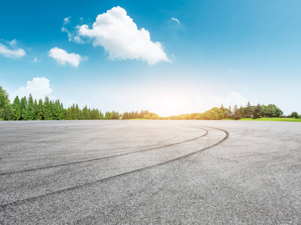 istock empty asphalt road and green forest in summer 943631436