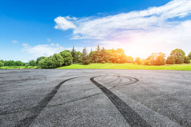 istock empty asphalt road and green forest in summer 943631464