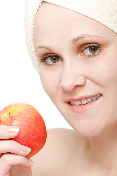 istock closeup woman face and apple 94363326
