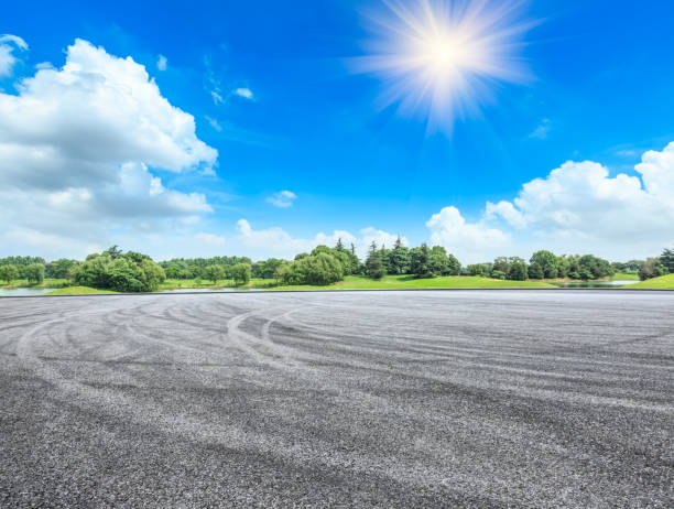 istock empty asphalt road and green forest in summer 943633786