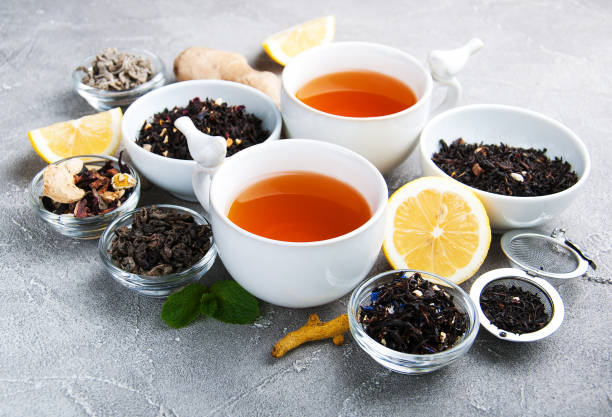 istock Cups of tea with aromatic dry tea in bowls 943634076