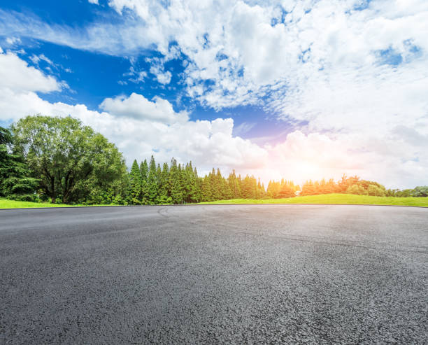 istock empty asphalt road and green forest in summer 943634080
