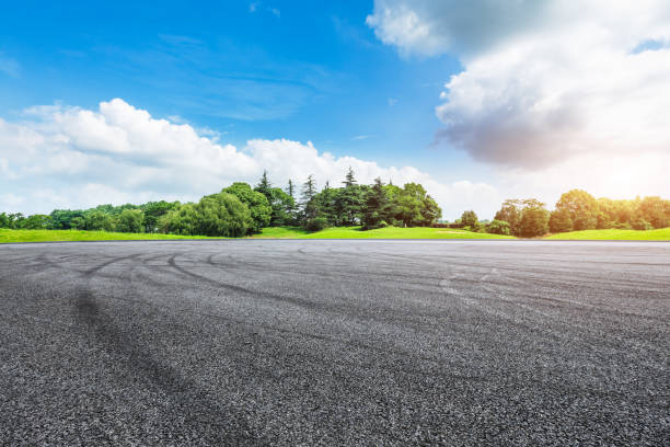 istock asphalt road ground and green forest in summer 943634098