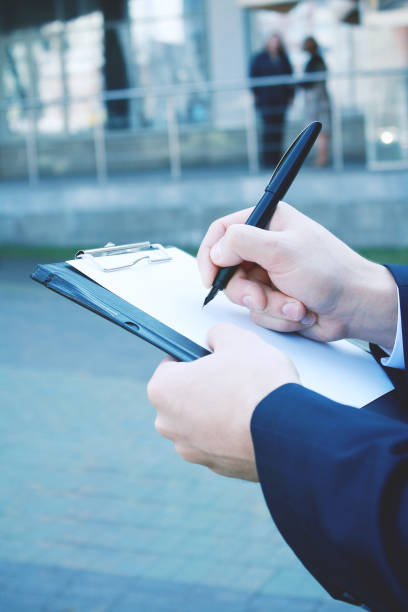 istock close up. businessman making notes on the clipboard 943639384