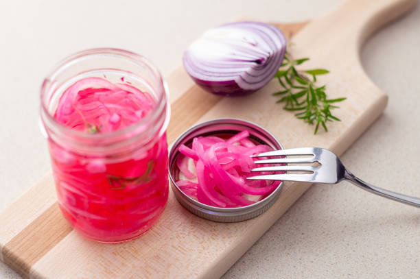 istock Pickled red onions in vinegar. 943645688