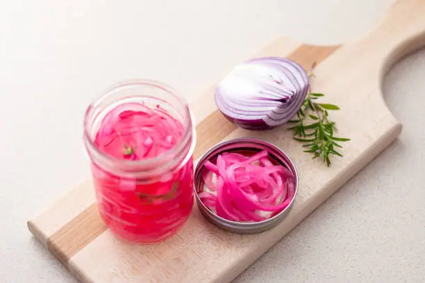 Homemade pickled red onions. Pickling red onions is easy, simply marinate the onions in a brine with vinegar, salt and herbs. Pickled food can be preserved in glass jar for a very long time!