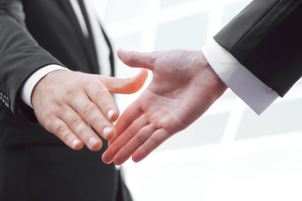istock close up. handshake business partners on blurred background 943646122