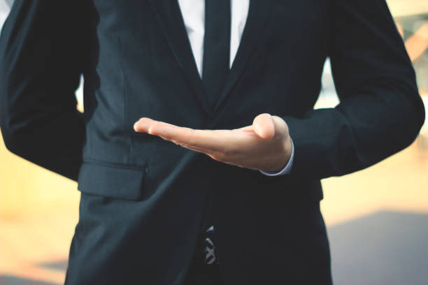 istock close up.businessman with empty hand on blurred background 943646166