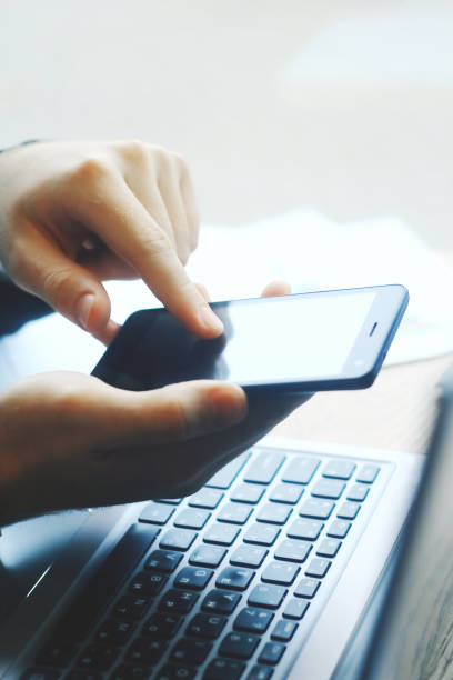 istock closeup.businessman typing SMS on the smartphone 943646244
