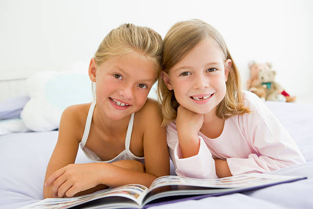 istock Girls In Their Pajamas, Reading A Book 94364691