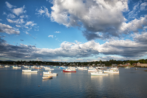 Dramatic cloud formations over small fishing and lobster boats in Southwest Harbor, Mount Desert Island, Maine USA