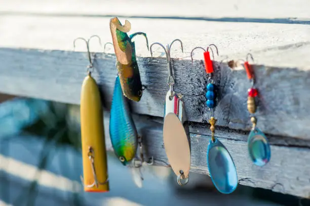 baubles and hooks for fishing close-up on a wooden pier