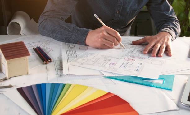 istock Architect working in office with house project on desk 943652996