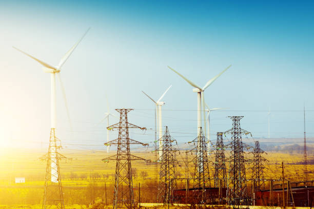 istock Power poles with wind turbines in autumn 943657192