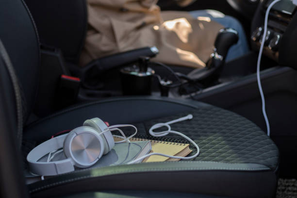 istock earphone and books on car seat 943659758