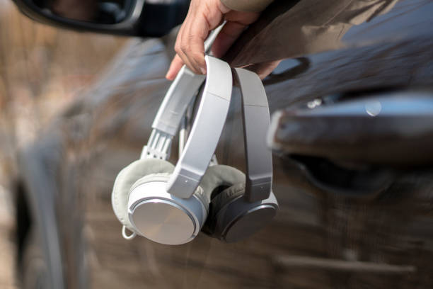 istock hand holding earphone, waiting in car 943659806