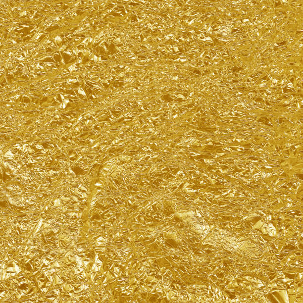 istock Gold foil leaf shiny texture, abstract yellow wrapping paper for background and design art work. 943668560