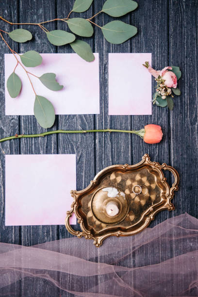 istock wedding decor with a rose and invitations, on a wooden 943670854