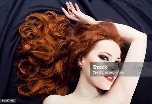 Red Haired Woman Looking At Camera Seductively Laying Down Stock Photo - Download Image Now