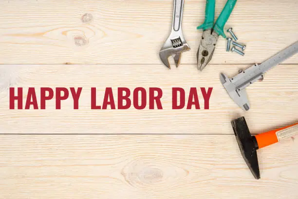 happy labor day, red text with tools over rustic wooden planks