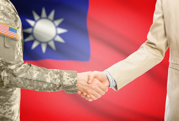 USA military man in uniform and civil man in suit shaking hands with adequate national flag on background - Republic of China - Taiwan stock photo