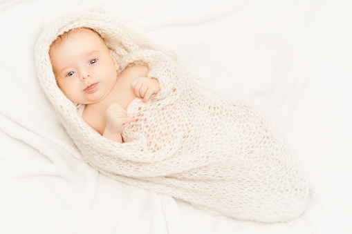 Newborn Baby, New Born Kid Swaddled in White Blanket, one month old Infant Child Portrait