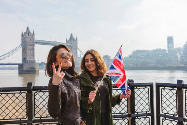 istock Beautiful girls carying British flag 943681744