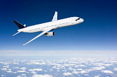 Passenger airplane flying above clouds