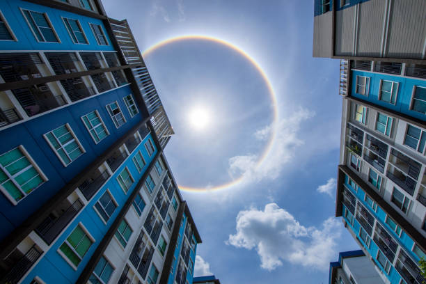 sun corona rainbow clouds and blue sky background , circumscribed halo - circular skirt fotos imagens e fotografias de stock