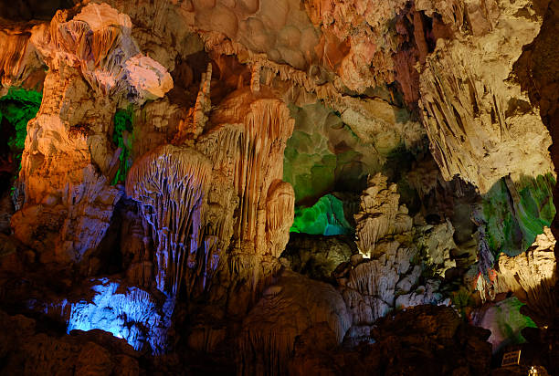 istock Stalactites and Stalagmites in Illuminated Cave in Halong Bay 94368252