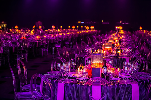 Purple and red decor with candles and lamps for corporate event or gala dinner