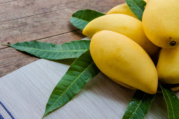 istock sweet yellow mango fruit on summer on wood table 943691390