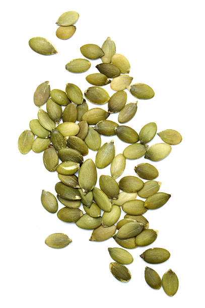 Green pumpkin seeds on white background